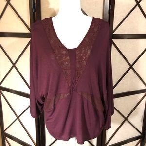Jennifer Lopez maroon batwing blouse.